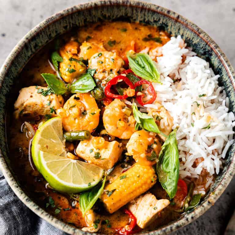 Thai red curry in a bowl with vegetables and chicken.